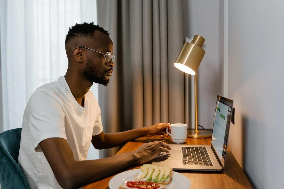 A person downloading an online doctor's note on a laptop.