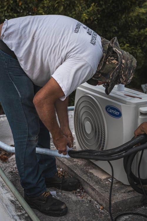 A technician cleaning the internal components of an air conditioner