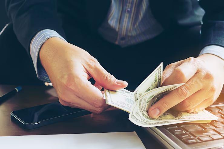 Businessman counting dollar banknotes