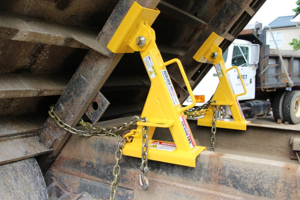 Truck bed locks being used on a dump truck during repair