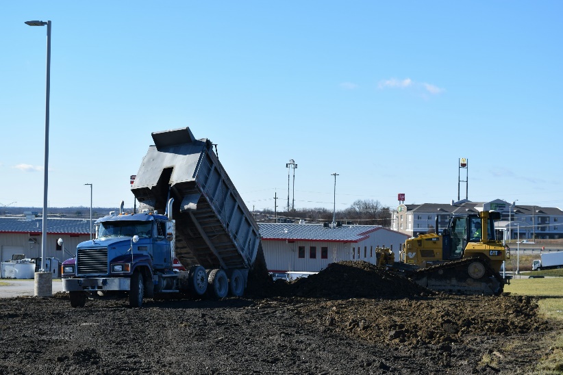 A dump truck is dumping dirt.