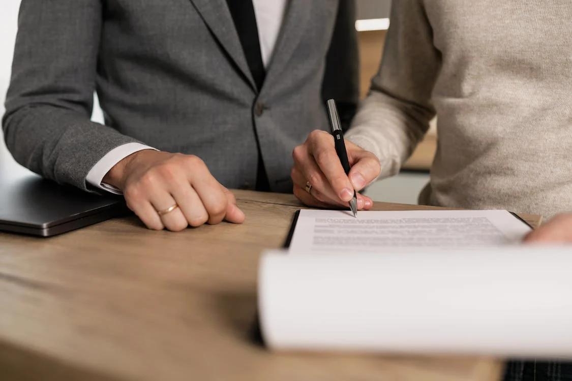 A man signing a contract