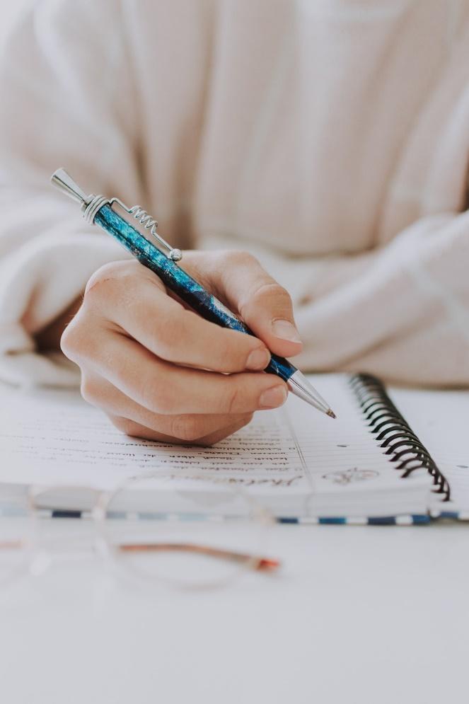 a doctor writing on a notepad