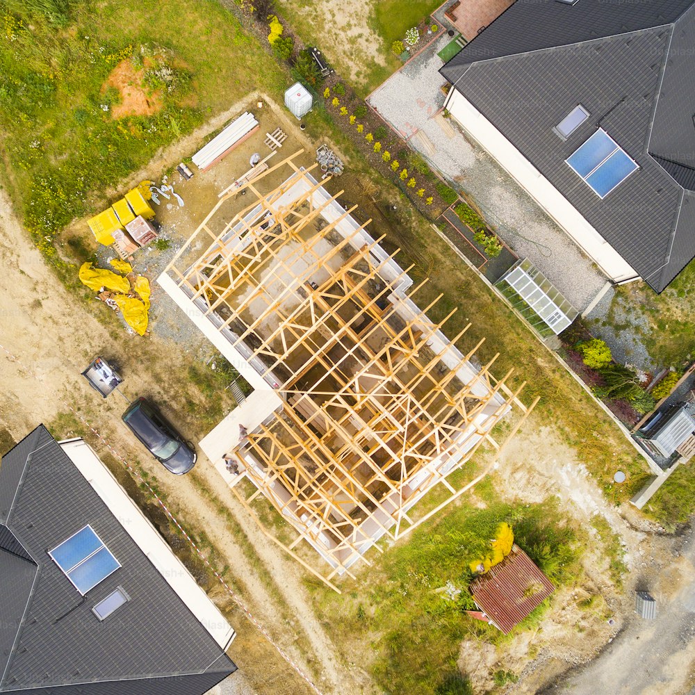 An aerial view of a construction site for a new family house in a suburban district.