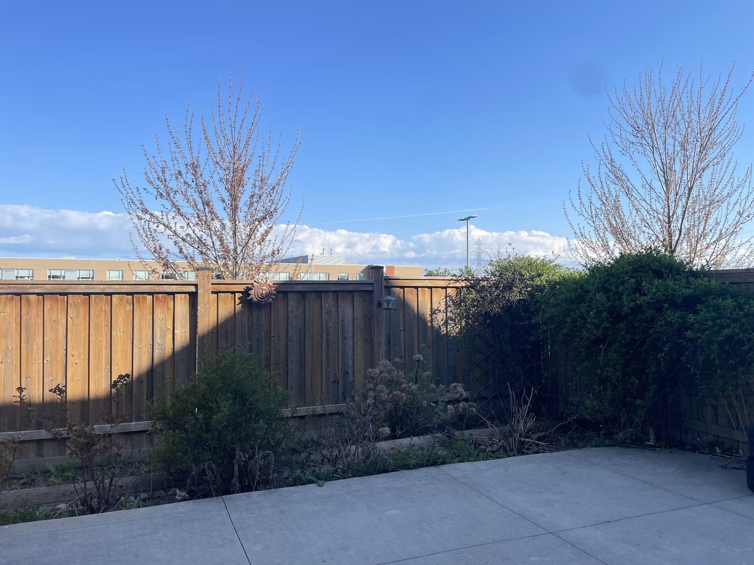 A wood fence in a back yard