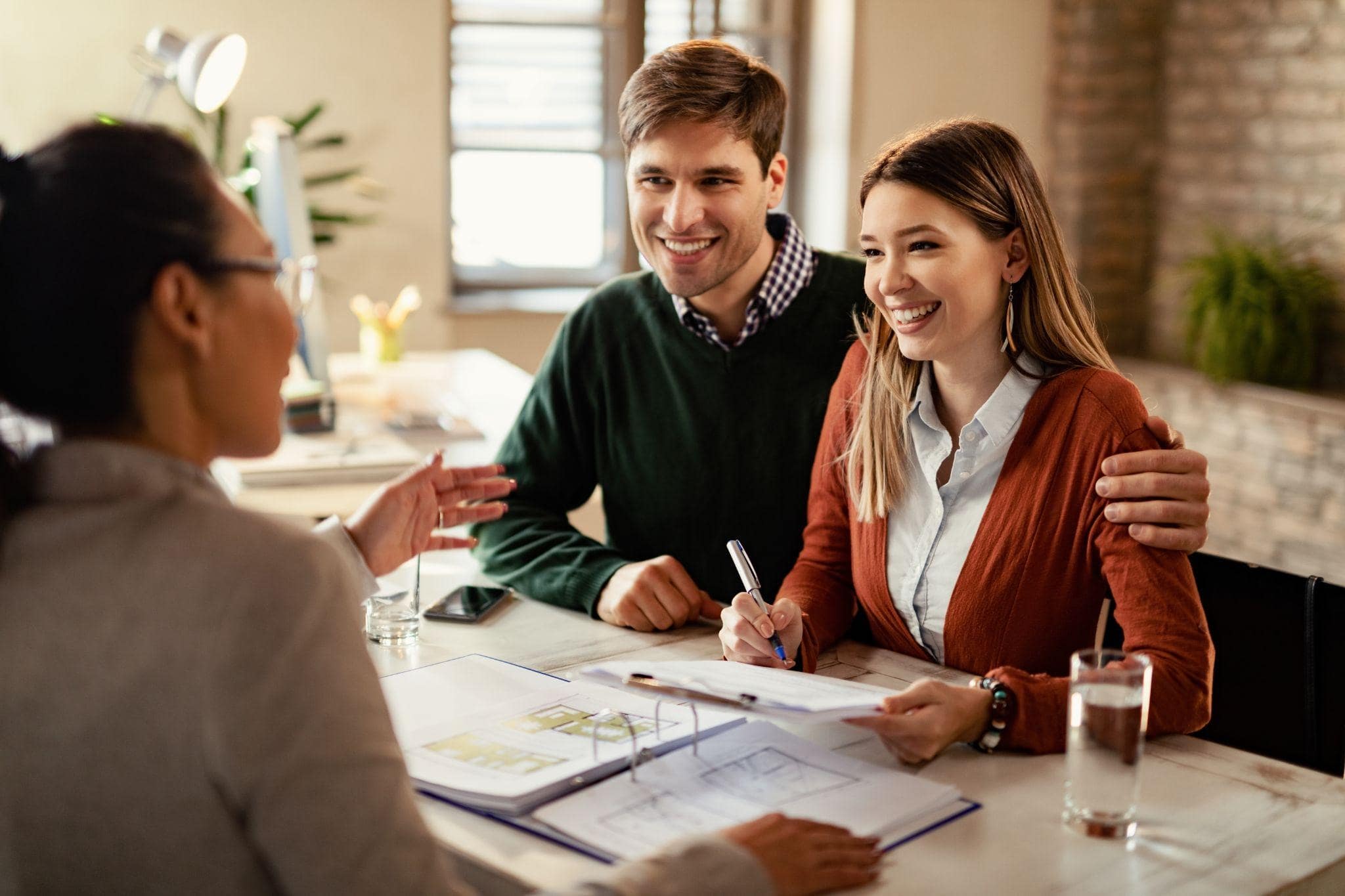 Young couple discussing life insurance at a Dallas office