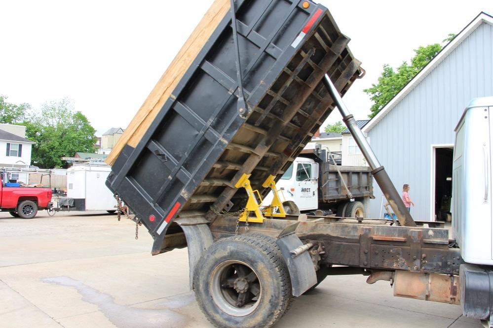 A BedLock unit securely positioned under a raised dump bed for safe maintenance operations