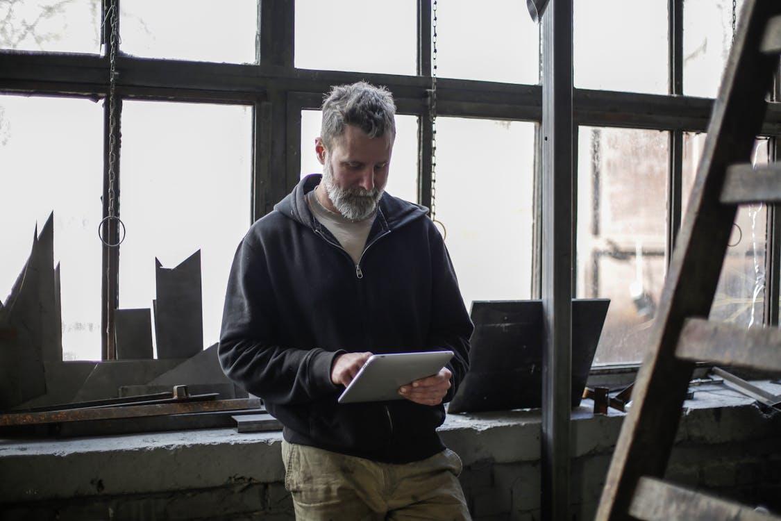 Aviation technician reviewing schematics on a tablet