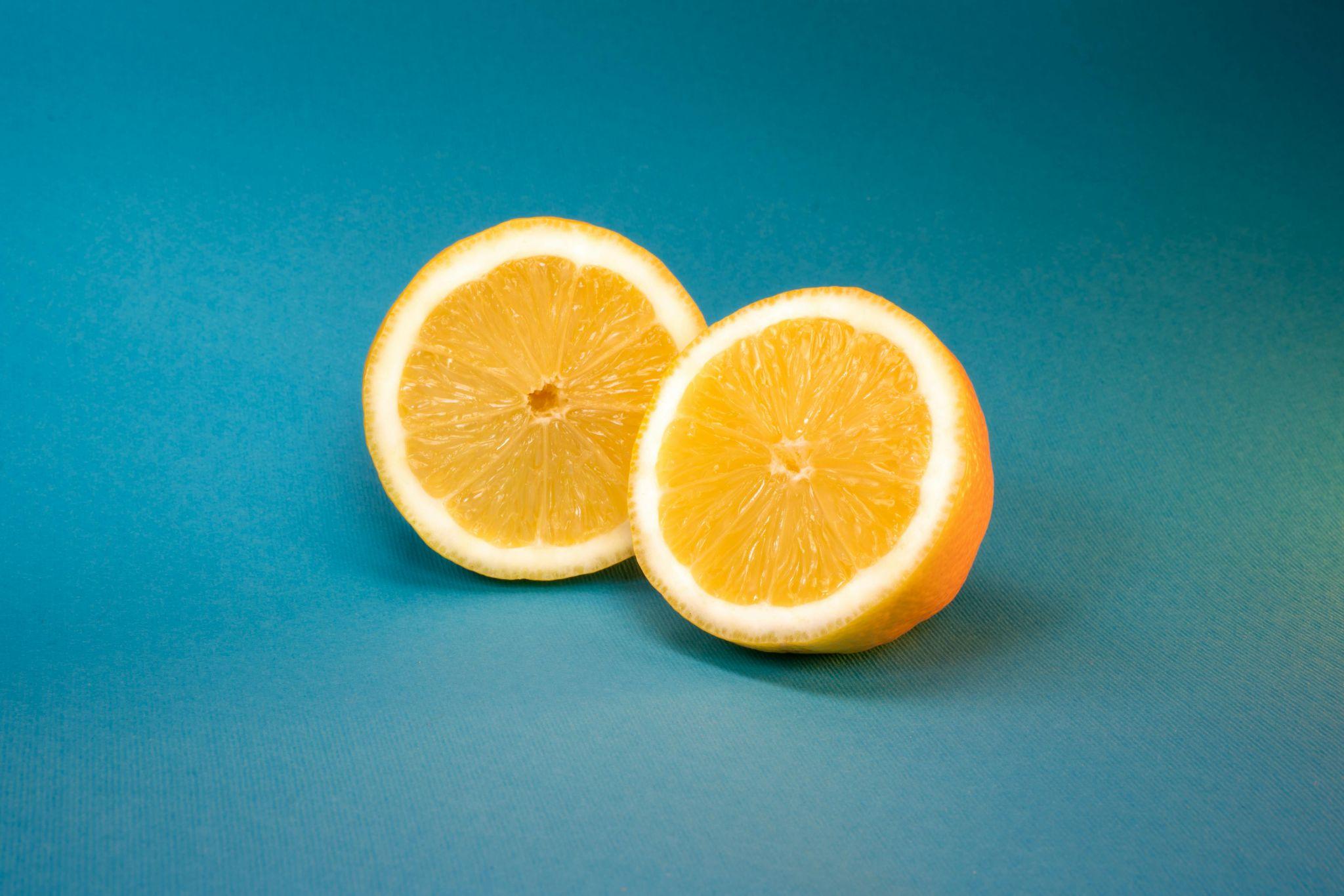 Two halves of a fresh orange showing the fruit’s inside.