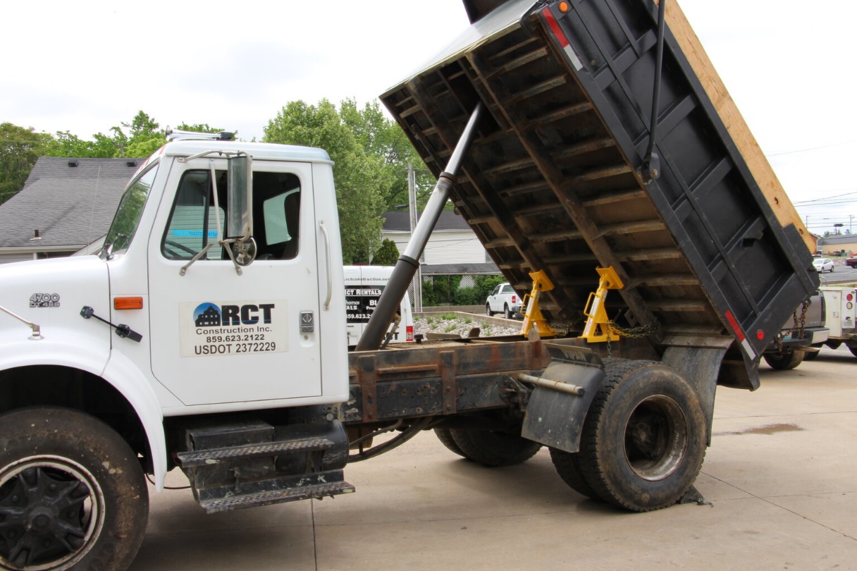 A raised dump bed on truck bed locks.