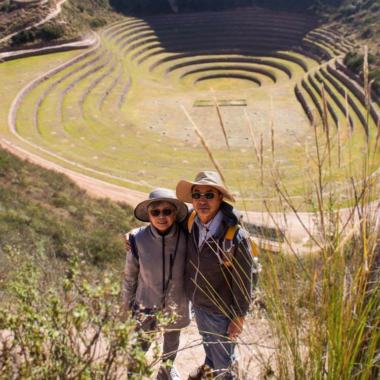 a tourist couple posing in front of the Sacred Valley