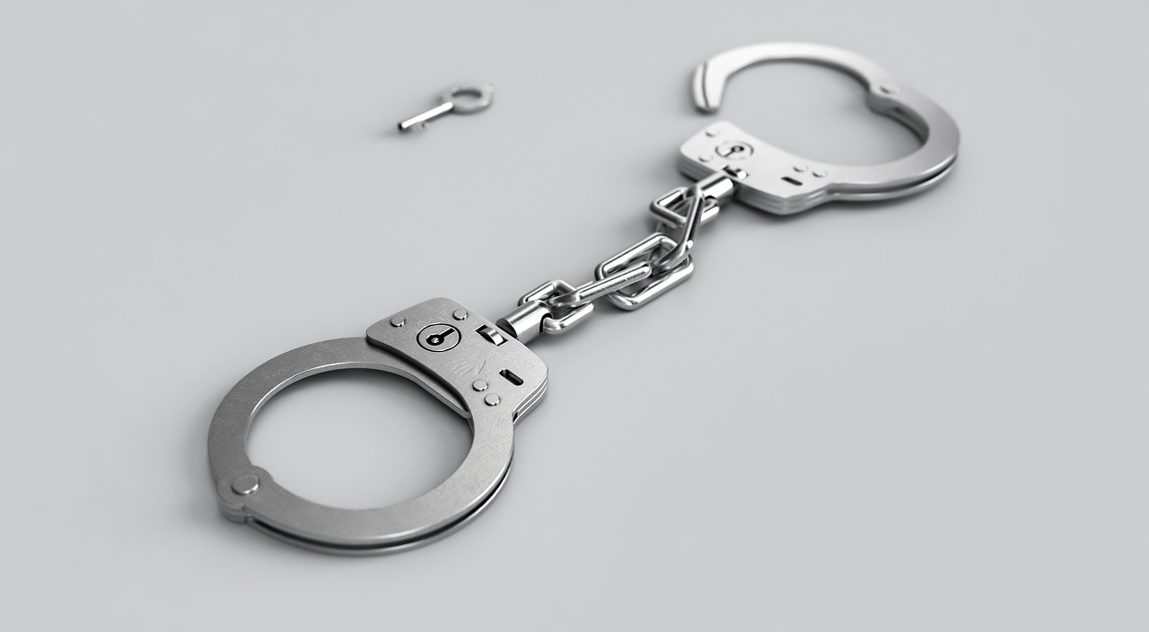 silver handcuffs on a grey background