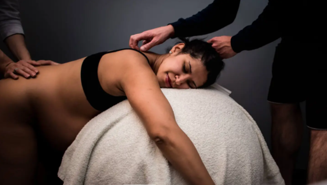 Woman in labor appearing calm and supported with a doula by her side