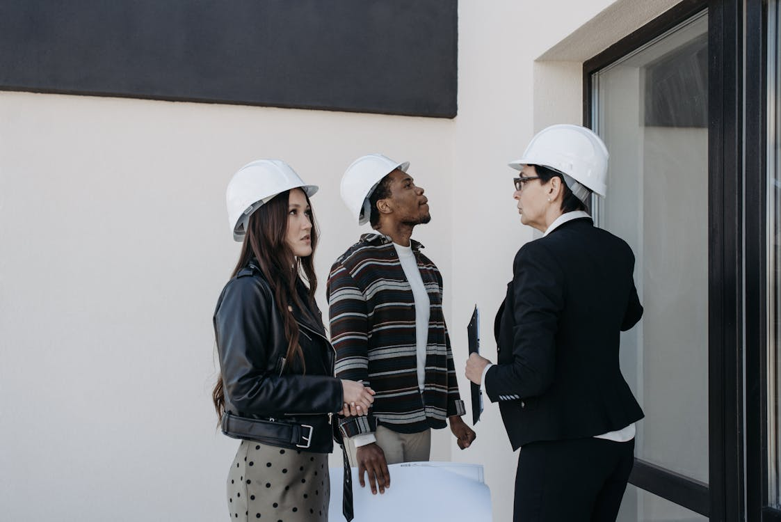 Real estate investors discussing property plans in a suburban setting