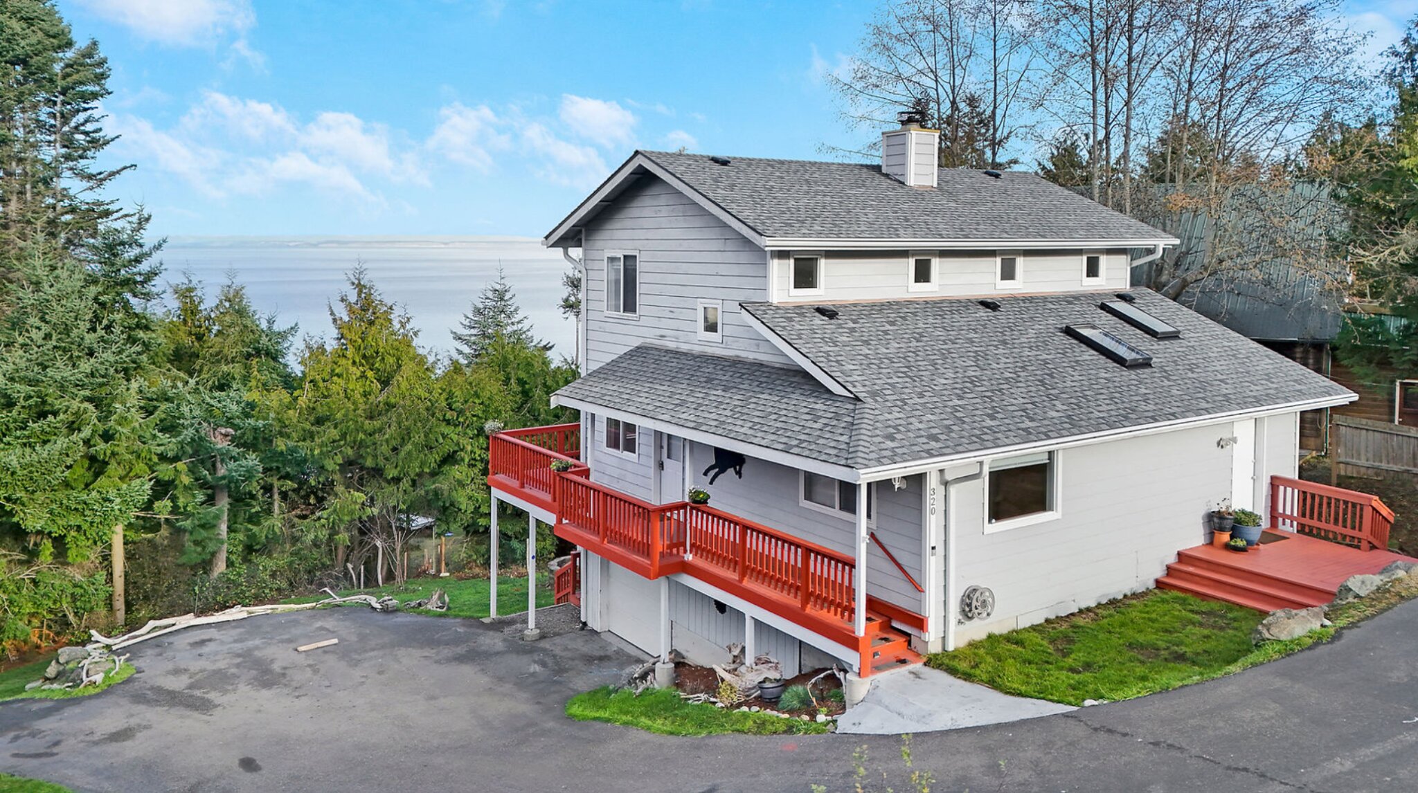 A beautiful red balcony and siding on a house.