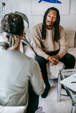 Mental health professional speaking with a client during trauma-informed addiction therapy