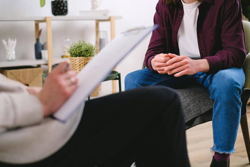 Therapist conducting a confidential counseling session with a client in a secure treatment environment